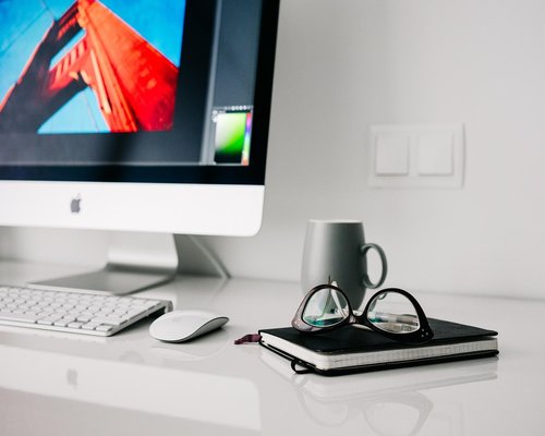 Person doing light stretching movements standing next to a home office desk